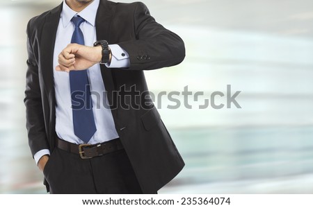 portrait of busy business man body looking at his watch in rush hour