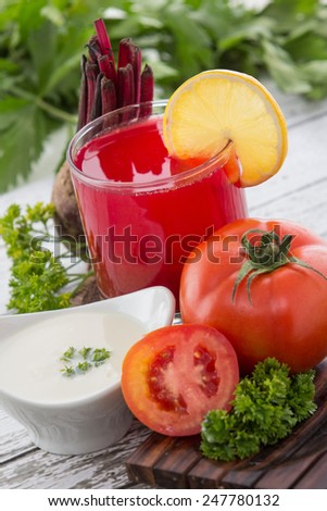Beetroot smoothies and tomato mix juice with yoghurt on wooden background