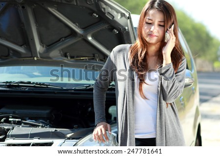 portrait of young woman with car called her friend asking for help
