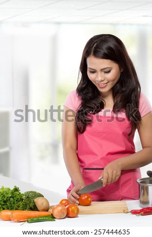 Young Woman Cooking in the kitchen. Healthy Food Diet. Cooking At Home. Prepare Food