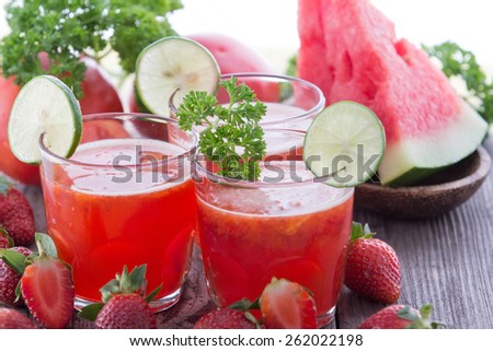 glass juice combining strawberry, watermelon, and tomato