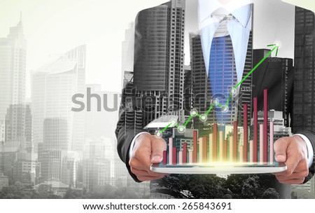 city and businessman using tablet computer. conceptual business image