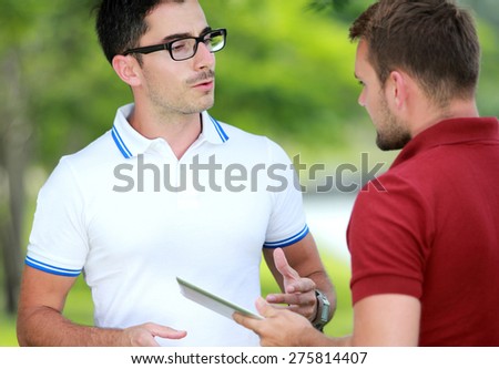 close up portrait of Two college students studying together at college park