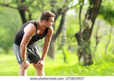 portrait of male runner taking a break after a tired running with copy space