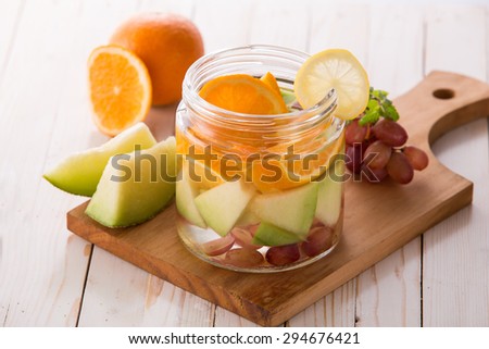 portrait of Summer fresh fruit drink. fruit Flavored water mix with orange, melon and grape