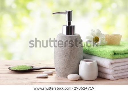 Spa still life with zen stone, essential oil, candle and pump container
