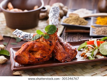 close up portrait of indian tandoori chicken garnished