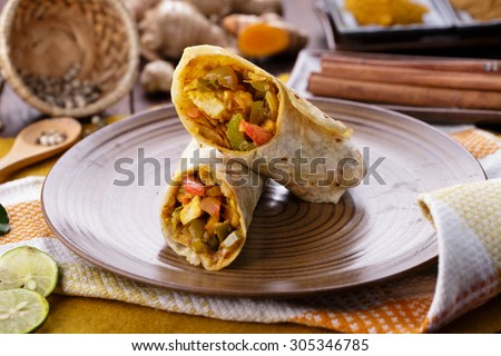 portrait of delicious spicy indian wrap paneer tikka