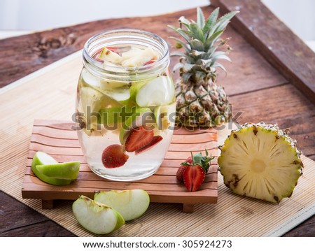 potrait of apple strawberry and pineapple infused water