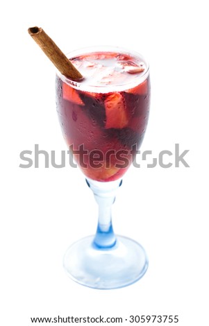 a glass of red sangria with cinnamon isolated on white background