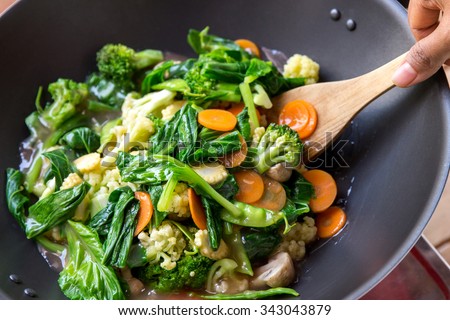 portrait of people cooking healthy vegetarian chinese food capcay