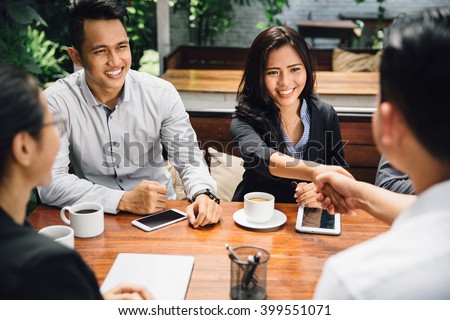 portrait of Business people shaking hands, finishing up a meeting