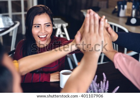 portrait of young enthusiastic team giving high five