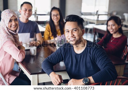 portrait of friends having fun together in a cafe. looking at camera
