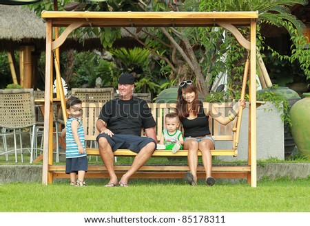 portrait of multi ethnic family sitting in the park