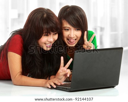 Two pretty women having a online chat using webcam