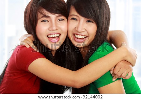 close up portrait of attractive two best friend hugging each other