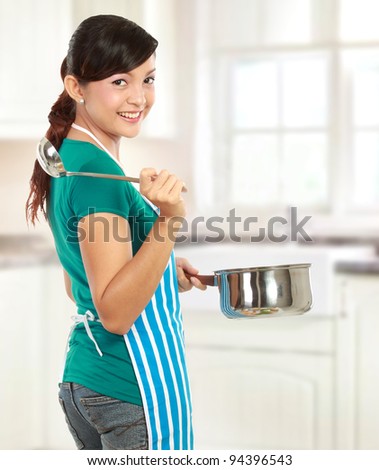 Happy young woman ready to cook some food