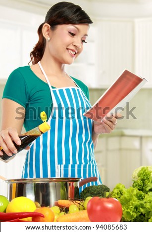asian woman cooking in the kitchen