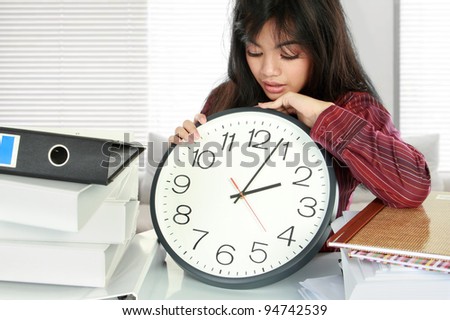 businesswoman holding a clock. dateline stress at work concept