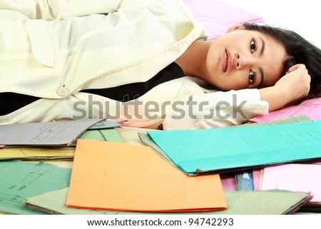 Portrait of stress business woman with document around her