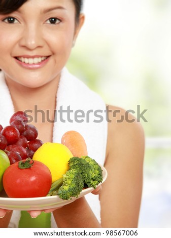 close up portrait of healthy fitness woman carrying a group of healthy food