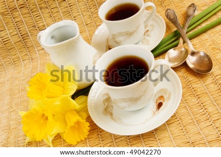 Two vintage cups of morning spring coffee and milk jug, soft focus