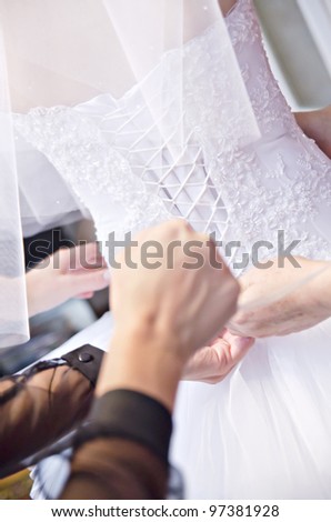 Wedding preparation: dressing a bride