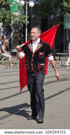 ZURICH - AUGUST 1: Swiss National Day parade on August 1, 2009 in Zurich, Switzerland. Representative of canton Appenzeller (Flag thrower) in a historical costume.
