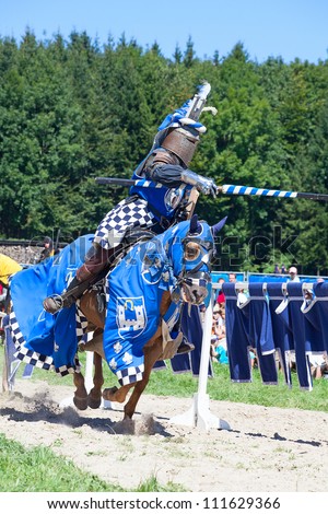 AGASUL. SWITZERLAND - AUGUST 18: Knight on the horse taking part in tournament reconstruction near Kyburg castle on August 18, 2012 in Agasul, Canton Zurich, Switzerland.
