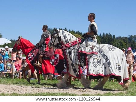AGASUL, SWITZERLAND - AUGUST 18: Unidentified men in knight armor on the horse ready for action during tournament reconstruction near Kyburg castle on August 18, 2012 in Agasul, Canton Zurich, Switzerland.