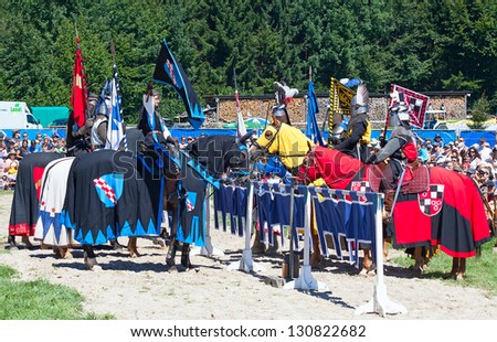 AGASUL, SWITZERLAND - AUGUST 18: Unidentified man in knight armor on the horse taking part in tournament reconstruction near Kyburg castle on August 18, 2012 in Agasul, Canton Zurich, Switzerland.