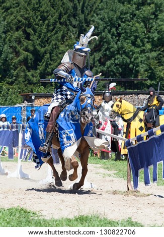 AGASUL, SWITZERLAND - AUGUST 18: Unidentified men in knight armor on the horse in action during tournament reconstruction near Kyburg castle on August 18, 2012 in Agasul, Canton Zurich, Switzerland.