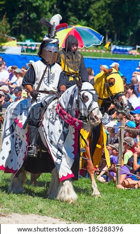 AGASUL, SWITZERLAND - AUGUST 18: Unidentified men in knight armor on the horse during tournament reconstruction near Kyburg castle on August 18, 2012 in Agasul, Canton Zurich, Switzerland.