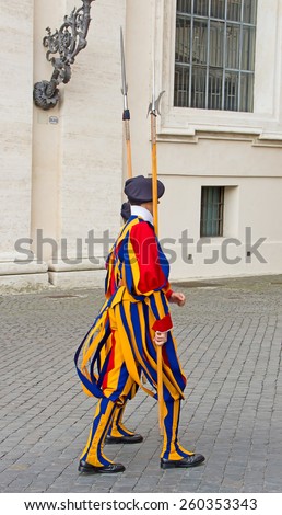 VATICAN CITY, VATICAN - AUGUST 1: Famous Swiss Guard surveil basilica entrance on August 1, 2014 in Vatican. The Papal Guard with 110 men is the world\'s smallest army.