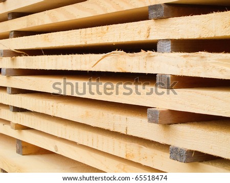 Stack of new wooden studs at a lumber yard