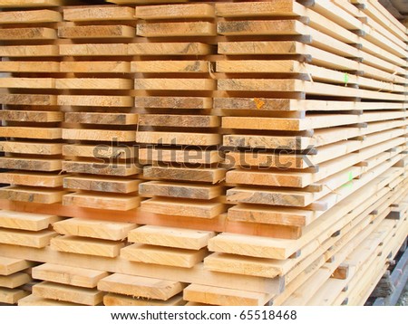 stock-photo-stack-of-new-wooden-studs-at-a-lumber-yard-65518468.jpg