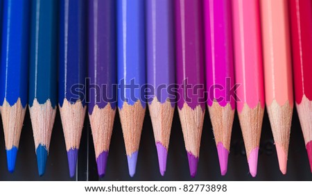 Set of pencils on black background