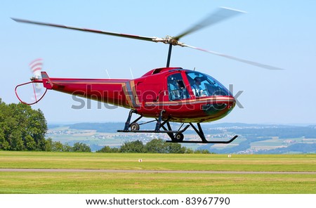 Helicopter taking off from the small airfield