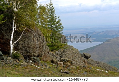 Nature, Russia, the Urals, a mountain landscape with lake, trees, birch against the huge boulders