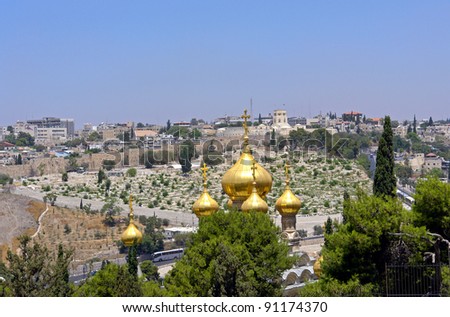 City landscape, Jerusalem, Sacred Maria Magdaliny\'s Church with gold domes in Gethsemane  garden on a background of Jerusalem.