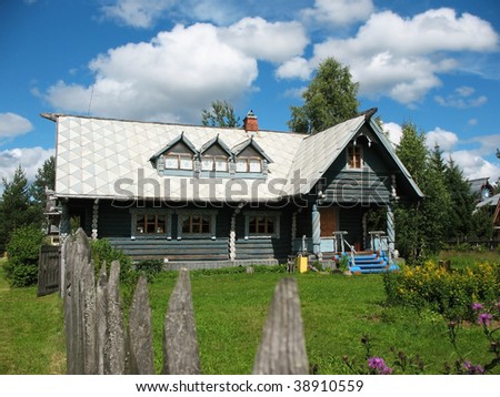 Russian style. Wooden blockhouse on the blue sky background.