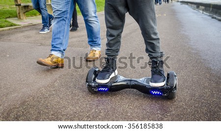 London, England - December 28, 2015: Person Riding a HoverBoard on a Public Footpath, They are now banned in all public places in the United |Kingdom.