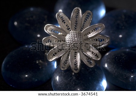 Silver ring in shape of flower  with blue gems