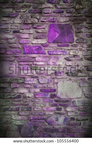 old stone background, fun colorful design with gray blocks and black vignette border, and purple rocks, background has abstract random pattern of stones in rock wall
