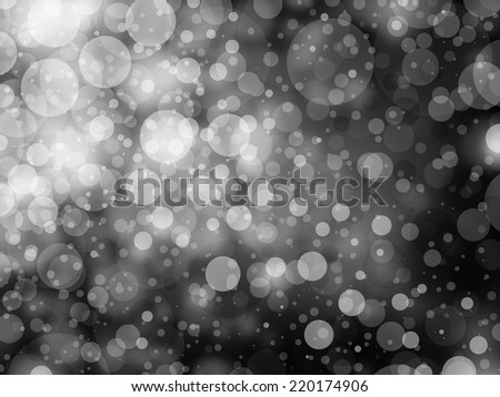 gray black and white bokeh background. Shimmering white Christmas lights or abstract falling snow. Festive party background. Fantasy night or magical background glitter sparkles