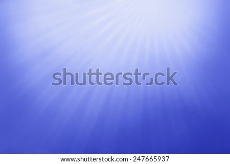 abstract blue sky background with cloudy white starburst or sunburst design in thin lines, radial striped design, rays of sunshine from heaven