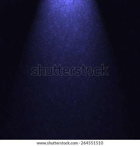 blue background with spotlight or sunbeam lighting with black dramatic shadows
