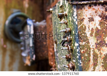 Screws on a rusty machine in an abandoned factory