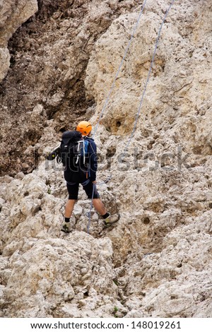 A climber is climbing down the high Alps mountain